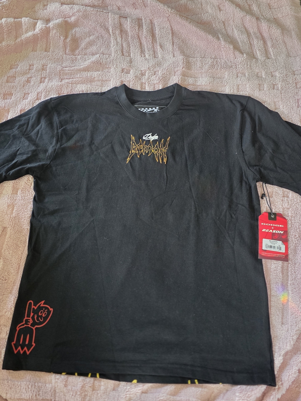 Reason Black Short-Sleeve Tee with Gold Chest Logo and Red Hem Graphic